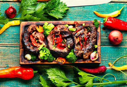 Deep fried meat with vegetable garnish. Roasted meat and vegetables. Copy space
