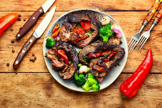 Deep fried meat with vegetable garnish. Roasted meat and vegetables. Copy space