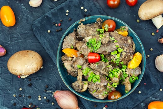 Chicken liver fried with mushrooms and tomatoes. Tasty liver in Georgian