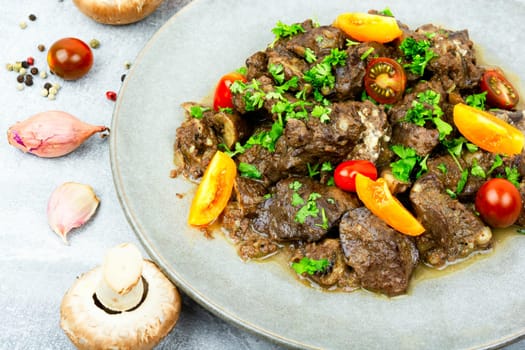 Chicken liver fried with mushrooms and tomatoes. Tasty liver in Georgian