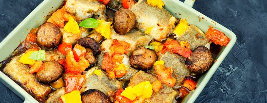 White fish hake cooked with mushrooms in the oven dish