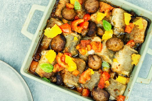 White fish hake cooked with mushrooms in the oven dish