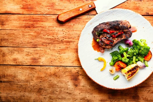 Deep fried meat with vegetable garnish. Roasted meat and vegetables. Copy space