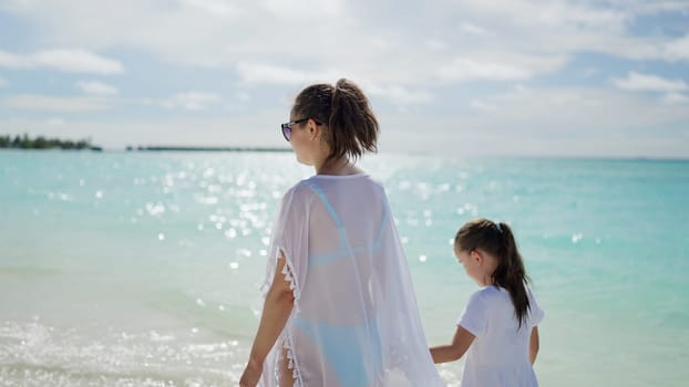 Woman With Child Daughter Together On Beach. Summer Vacation