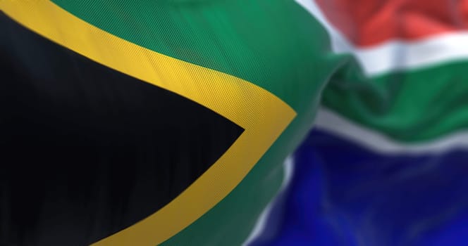 Close-up view of the South Africa national flag waving in the wind. The Republic of South Africa is the southernmost country in Africa. Fabric textured background. Selective focus. 3d illustration