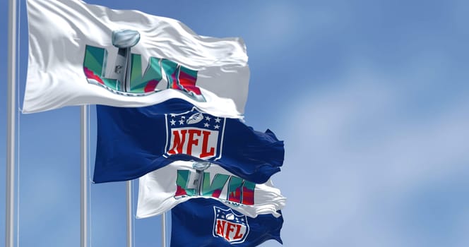 Glendale, US, Nov 2022: Flags of he 57th Super Bowl and NFL waving in the wind. The game is scheduled to be played on February 12, 2023 in Glendale, Arizona