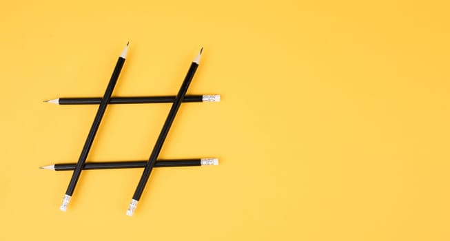 Hashtag made from pencils, social media communication, influencer and followers, viral content trend, yellow color