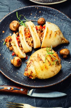 Grilled squids with vegetable stuffing. Stuffed calamari in grill pan