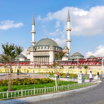 Istanbul, Turkey - September 2 2022: Pedestrians walking in front of Taksim Mosque, at Taksim Square, Beyoglu district, central Istanbul, in a sunny summer day