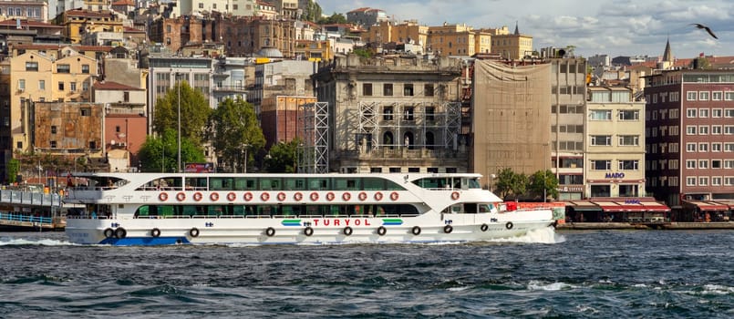 Istanbul, Turkey - August 29, 2022: Modern ferry boat sailing in Marmara sea, with city view in the background