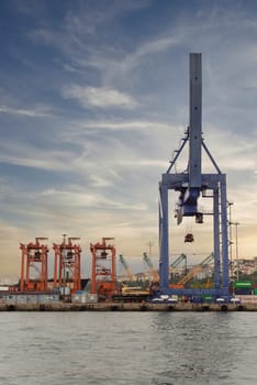 Istanbul, Turkey - August 25, 2022: Day shot of the cranes in the shipyard of the Port of Haydarpasha, Istanbul, Turkey with city view in the background