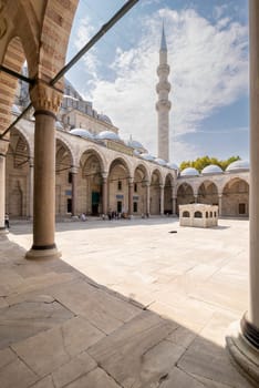 Istanbul, Turkey - August 26, 2022: Courtyard of Suleymaniye Mosque with few tourists walking around, an Ottoman imperial mosque located on the Third Hill of Istanbul