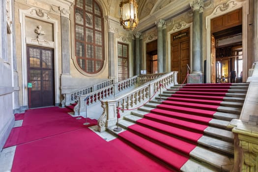 Turin, Italy - Circa August 2021: marble staircase in historic palace with luxury interior - Savoia Royal Palace