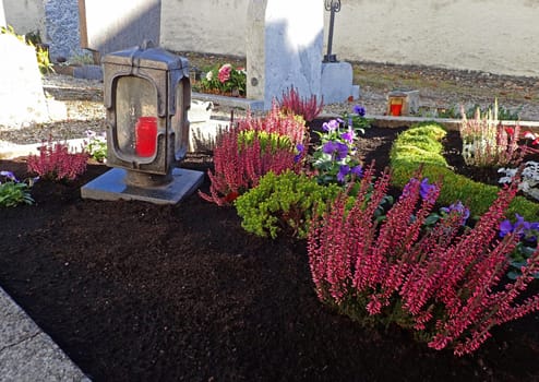 Beautifully decorated graves in a cemetery on All Saints Day in autumn