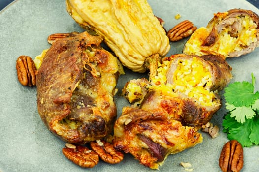 Tasty baked meat roulade stuffed with pumpkin in the oven dish. Autumn recipe.