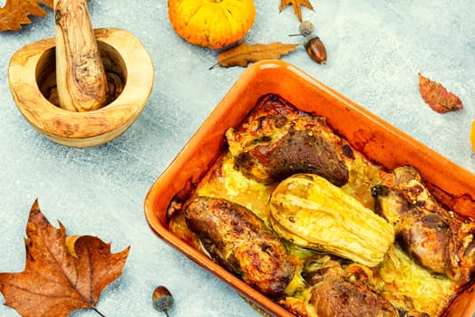 Tasty baked meat roulade stuffed with pumpkin in the oven dish. Autumn recipe.