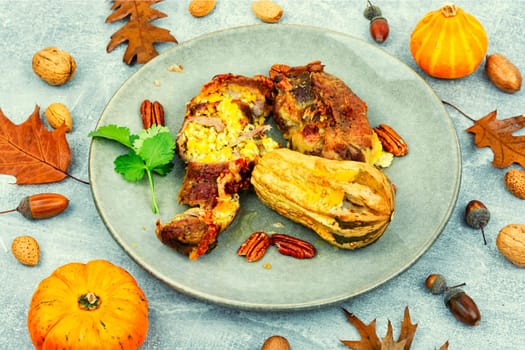 Tasty baked meat roulade stuffed with pumpkin in the oven dish. Autumn recipe.