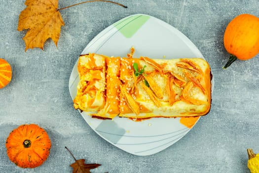 Homemade pie, autumn recipe. Cottage cheese pumpkin casserole decorated with orange peels.