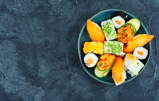 Traditional sushi rolls on the plate. Sushi menu. Japanese food. Space for text