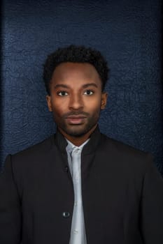 twenty year old man headshot suit style on black background vertical dark portrait serious businessman