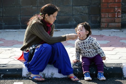 Mother and daughter eating ice cream outdoors