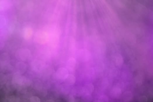 Purple bokeh background with defocused round lights and sunbeams, flare overlay