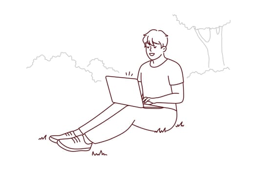 Smiling young man sit on ground in park working on laptop. Happy male freelance type on computer outdoors. Remote job or education. Vector illustration.