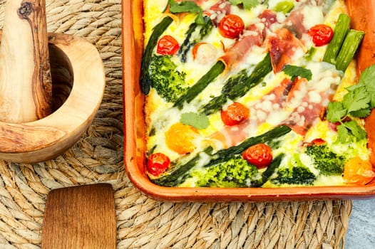 Asparagus wrapped in bacon with grated parmesan cheese.Food background