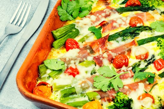 Asparagus wrapped in bacon with grated parmesan cheese.Food background