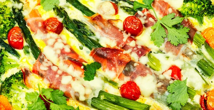 Asparagus wrapped in bacon with grated parmesan cheese.Food background