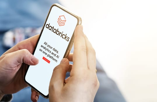 San Francisco, CA, US, May 2022: Female hands holding a phone with Databricks mobile app on screen. Databricks is an enterprise software company. Illustrative editorial