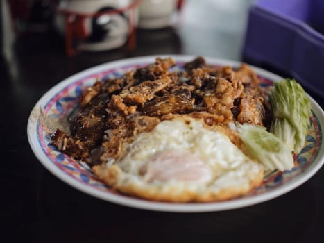 Fried Pork with Garlic, Pepper and fried egg on rice.