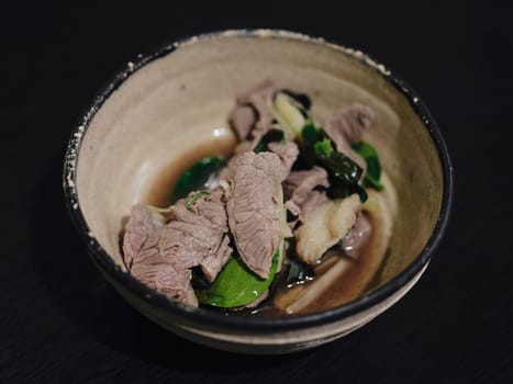 Boiled Beef dip with hot in  bowl and sour sauce in Thai food style