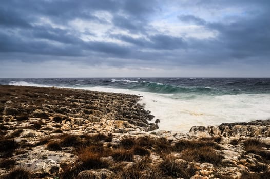 Waves and spray on the rocky coast by the sea