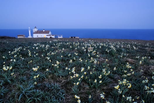 Lighthouse by the sea at dusk