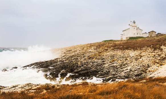 Surf by the sea at lighthouse in Istria