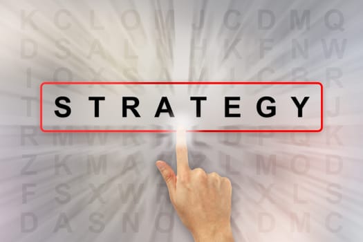 hand clicking business strategy on word search puzzle