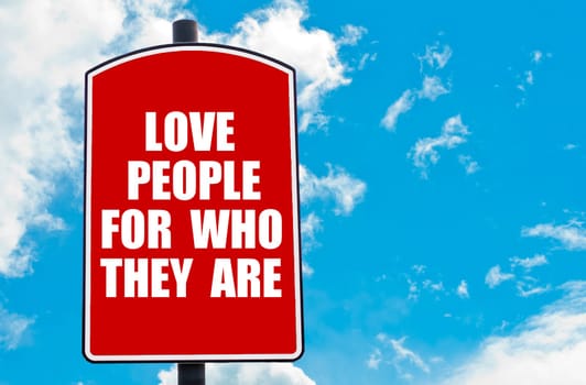 Love People For Who They Are motivational quote written on red road sign isolated over clear blue sky background. Concept  image with available copy space