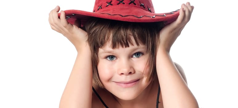 Beautiful little girl in a red hat on a white background