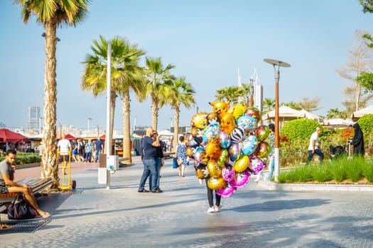 Dubai, UAE, February 23, 2018: A party balloon vendor at the Jumeirah Beach Residence (JBR) Walk - a polular destination for food, shopping and entertainment