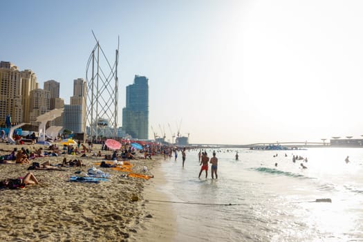 Dubai, UAE, February 23, 2018: Crowded beach at Jumeirah Beach Residence in Dubai, UAE