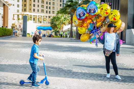 Dubai, UAE, February 23, 2018: A party balloon vendor at the Jumeirah Beach Residence (JBR) Walk - a polular destination for food, shopping and entertainment