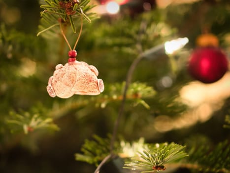Christmas. Christmas decoration. Casing of a snail spoiled with glitter and rhinestones hangs on Christmas tree. Christian holiday. Photo from life