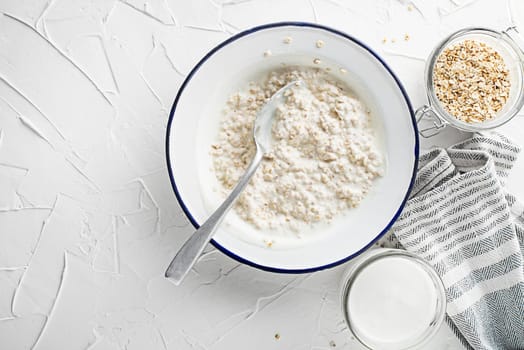Oatmeal plate. A plate of oatmeal served with fresh milk. Healthy food, diet. Top view.