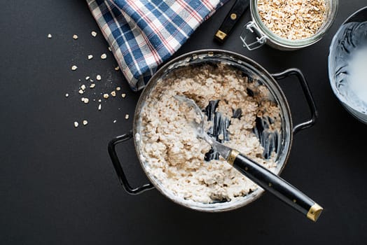 Oatmeal plate. Cooked oatmeal served with fresh yogurt. Healthy food, diet. Top view.