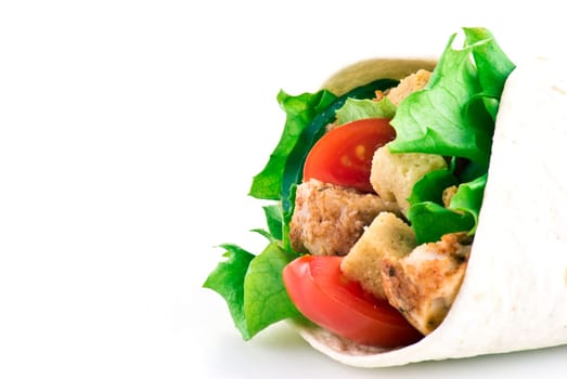 Tortilla filled with lettuce chicken tomatoes and cucumber