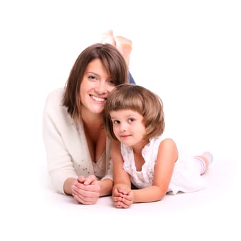 A portrait of a mother and her baby girl lying on the floor and smiling over white background