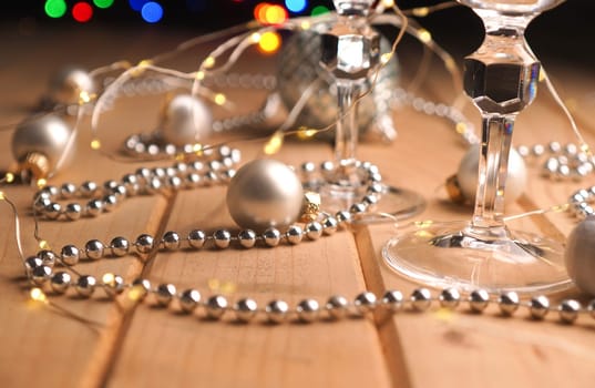 Two glasses of champagne on a wooden table with festive decoration, Christmas or New Years concept