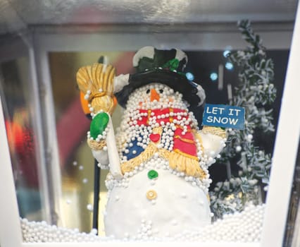 A little snowman with the written let it snow