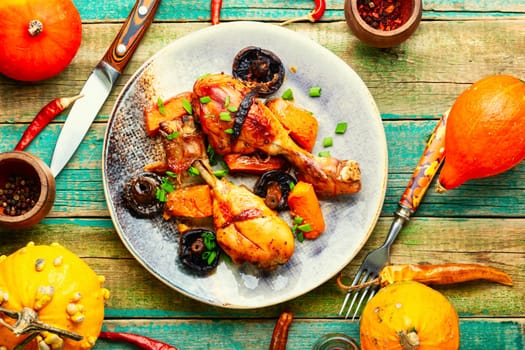Chicken legs baked with pumpkin. Thanksgiving Day.